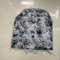 Detailed shot of black and white camo knit beanie featuring trendy fringe and distressed holes - 11# Black with White Thread