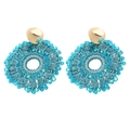 Close-up of handmade woven sky blue bead earrings with round hollow structure - Blue