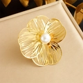 Elegant gold flower brooch with central pearl and hollow leaf texture on beige leather stand - Single Ring-White Pearl (R485)