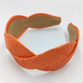 Close-up of orange raffia braided headband with textured weave and soft inner lining - Orange