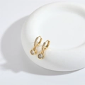 Gothic style gold fish tail earrings with round clear zircon pendant on ceramic tray - Large Round Zirconia