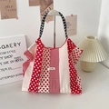 Detailed close-up of a red polka dot canvas tote bag featuring branded Sozakka woven label - Vertical Stripe Polka Dot Red