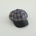 Close-up of checkered newsboy hat with blue plaid fabric and black faux leather brim - 50-52cm (2-5 Years) / Blue