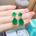 Teardrop emerald gemstones drop earrings in silver setting displayed on hand - Style B Emerald Green