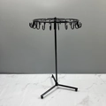Rotating black iron jewelry display stand with multi-hook design for necklaces and earrings - Black Triangle Base