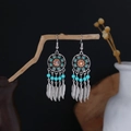 Detail of silver Bohemian tassel earrings with blue beads and metal feather pendants - Cyan Blue Orange Beaded Feather Tassel Style (E6135-1)