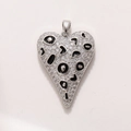 Macro shot of silver heart pendant with leopard pattern enamel and sparkling zircons - Silver Black Enamel Leopard Heart