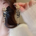 Close-up of golden flower earrings with dangling black and grey crystal tassel beads - Gold Flower Black Gray Beaded Tassel (69#)