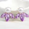 Close-up of luxury gold earrings with white pearls and purple marquise crystals - Purple