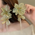 Exaggerated light green lace flower earrings with hanging crystal tassels on a model - Pale Green