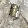 Detailed view of silver metallic lava texture hair clip on a clear glass plate - Silver