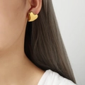 Minimalist gold heart-shaped stud earring worn by a model with a polished finish - Small (F1072) / Gold
