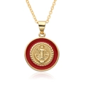Macro shot of gold-plated St. Benedict religious pendant with red enamel detailing - Style A015