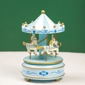 Detailed view of light blue carousel music box with gold trim on a white textured surface - Floral Blue