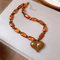 Macro view of vintage beaded necklace featuring brown resin beads and a heart pendant - Amber Heart Style (36#) / Brown
