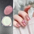 Pale green aurora nail powder showing iridescent pink-purple effect on nails - Aurora Red