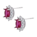 Detailed macro view of silver stud earrings with oval red zircon and pavé white stones - Platinum Rose Red Zirconia