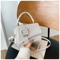 Elegant off-white rectangular crossbody bag with gold metal buckle on a black stool - Off White
