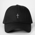 Detailed view of white cross embroidery on premium black cotton twill baseball cap - Black