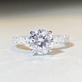 Macro shot of 3-carat moissanite ring showing brilliant fire and four-prong silver setting - US 5 / Round Cut (3 Carat)