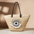 Grand sac de plage en paille avec motif œil brodé et poignées en cuir noir élégant - Beige