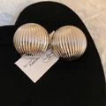 Detailed close-up of silver striped metal sphere earrings on a black velvet heart base - Silver Striped Round (925 Silver Pin)