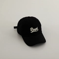 Close-up of white Royal embroidery on a black cotton twill baseball cap for kids - 52-54cm (3-8 Years) / Black