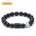 Macro detail of Scorpio beaded bracelet featuring black onyx beads and engraved zodiac charm - Scorpio
