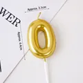 Shiny gold metallic number 0 birthday candle with plastic stand on white background - Golden Number 0