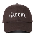 Close-up of white Groom embroidery on a dark brown cotton baseball cap for weddings - Groom (GROOM) / Coffee