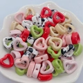Colorful heart-shaped ceramic beads with ink wash texture in a white decorative bowl - Multi-color