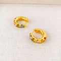 18K gold plated hoop earrings with rainbow colored cubic zirconia stones on fabric background - Colorful