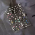 Detail of white butterfly nail stickers with pearlescent shell luster effect - to3888 Shell Sheen Bow