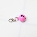 Detailed close-up of a pink metal bell featuring a silver lobster clasp for pet collars - Painted Rose Red
