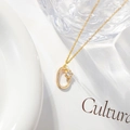 Elegant gold letter necklace with zircon pendant and flower detail on white background - Letter O