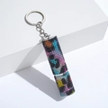 Macro view of leopard print rhinestone perfume bottle keychain with crystal details - C15-Colorful Leopard