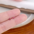 Minimalist tiny rose pink zircon stud earrings shown on fingertip for size reference - Vertical Prong No.3 / Coral Pink