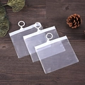 Three minimalist transparent pencil cases with white zippers on a rustic wooden desk - 10*10CM / Frosted