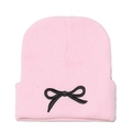 Detail of pink knitted beanie featuring a black embroidered bow on the folded cuff - M (56-58cm) / Pink