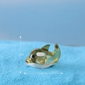 Miniature yellow-green resin dolphin figurine on blue sand, size 2.7cm by 1.6cm - No. 2 Swimming Whale