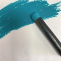 Single cyan blue oil pastel with smooth texture stroke on white paper surface - Cyan Green