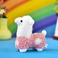 Detailed side view of a cute pink and white spotted alpaca plush toy keychain pendant - Curly Alpaca / 12cm / Pink