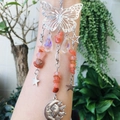 Detail of butterfly suncatcher with colorful stones and faceted rainbow crystal drops - Red Agate