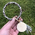 Detail of leopard print PU leather keychain bracelet with wooden tag and tassel - Yellow Leopard
