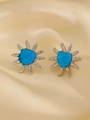 Star-shaped silver stud earrings with sparkling blue heart center on silk background - Blue Sun Starburst Style (Stainless Steel White K Blue Sun Z-057)
