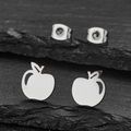 Polished stainless steel apple shaped stud earrings displayed on a dark textured stone - Silver Apple