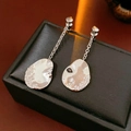 Macro shot of silver asymmetrical water-drop earrings with frosted texture on jewelry box - Silver (18K Gold Plated)