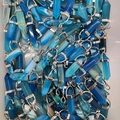 Blue agate hexagonal column pendant with silver metal bail clasp shown in bulk stock - Blue Agate