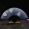 Detail of silk folding fan with white peony and butterfly patterns on dark blue surface - Black Bone Peony