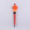 Detail of beaded ballpoint pen featuring orange silicone pumpkin and glittery red barrel - Yellow Pumpkin